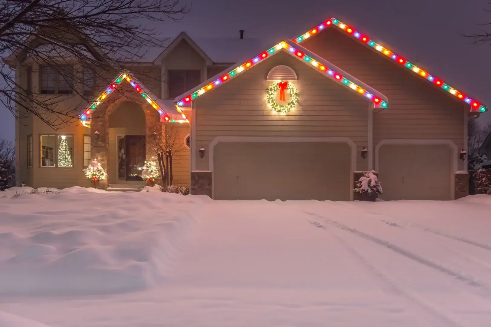 permanent lighting Christmas light installation illuminate a decorated house at night. Indianapolis Walden Window & Pressure Washing
