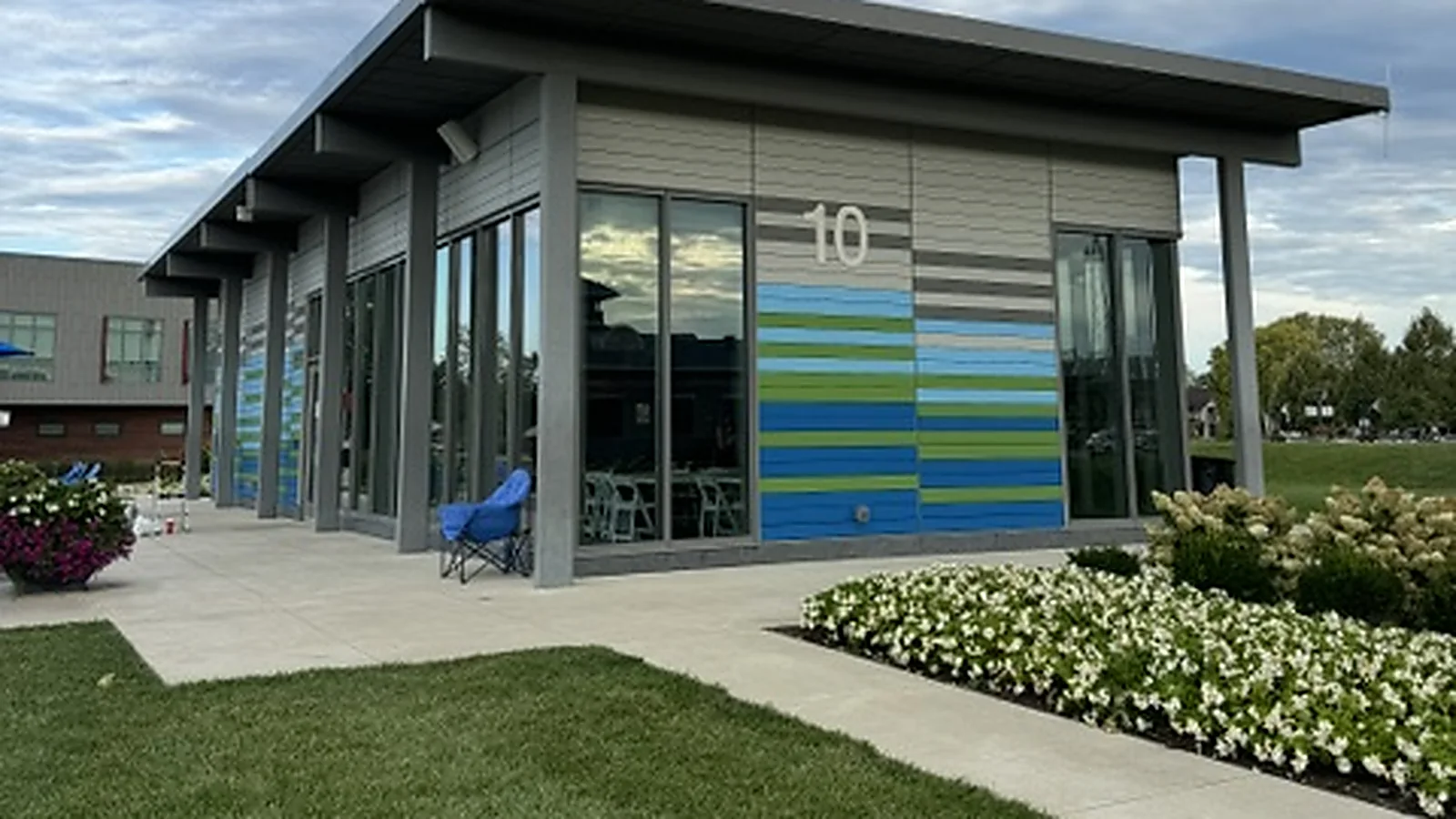A modern City of Fishers building with floor to ceiling glass and colored panel accents