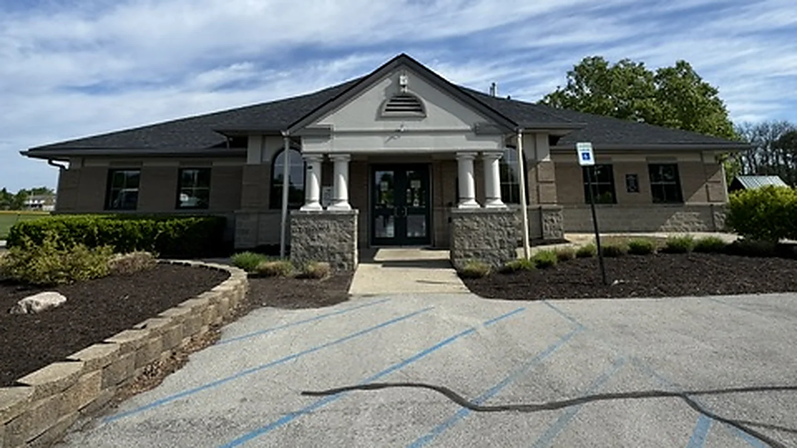 A City of Fishers building with a columned entry portico and glass entry doors