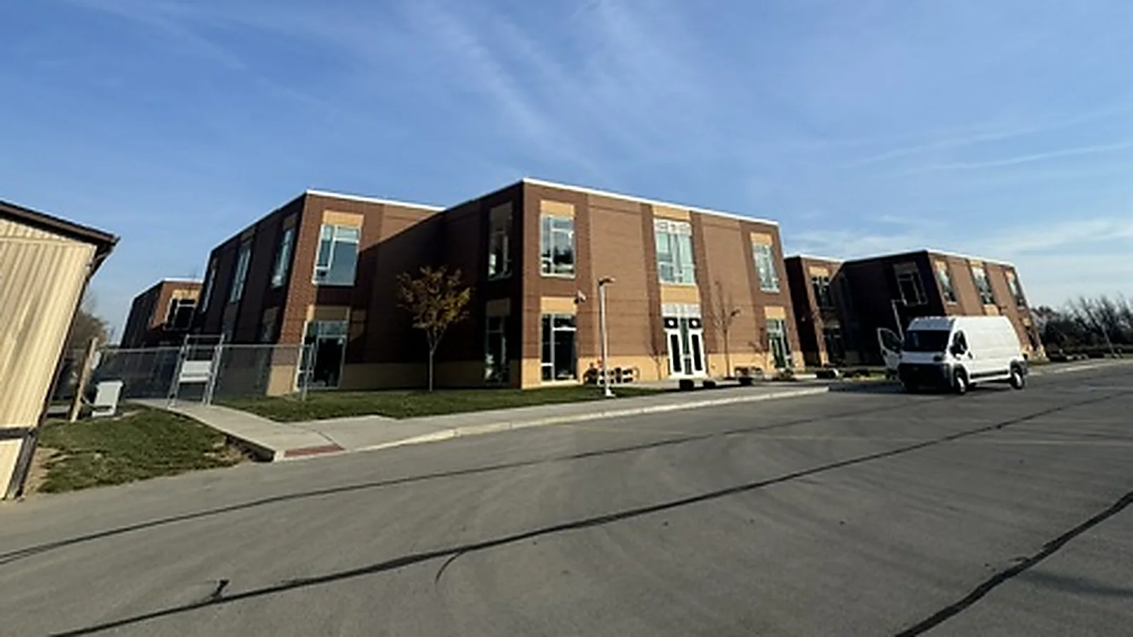 A two story brick Hamilton Southeastern school building with a Walden work van outside