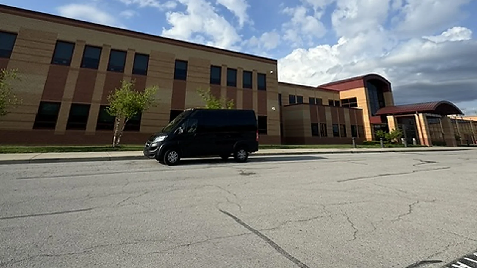 A Walden Window and Pressure Washing van parked at a Hamilton Southeastern school building